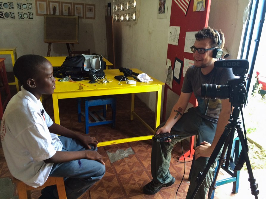 Jim Tuttle (right) interviews a student of the Liberia Visual Arts Academy.